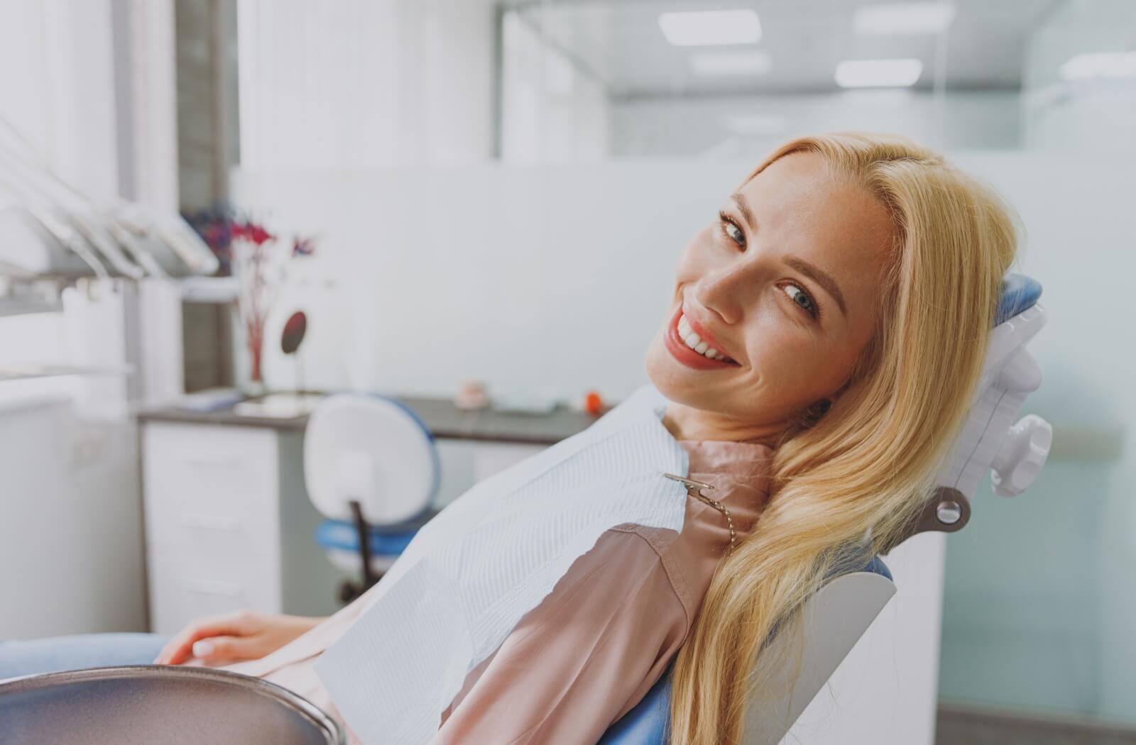 A person sits in the dentist's chair, happily waiting for their regular checkup and cleaning.