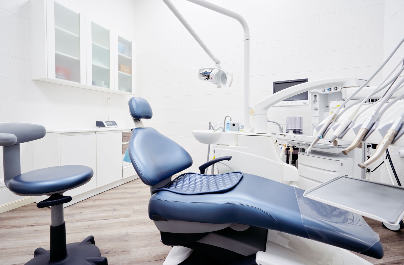 Modern dental treatment room with a blue dental chair and equipment for a sedation dentistry appointment.